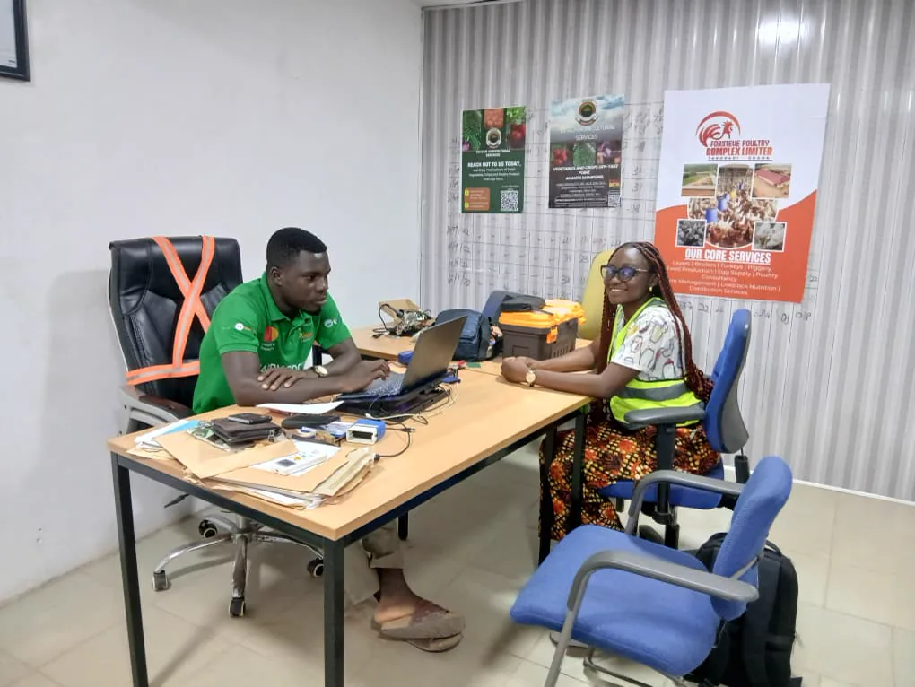 A Kuapa Dwaso representative in conversation with an Extech Agricultural Services team member in Takoradi