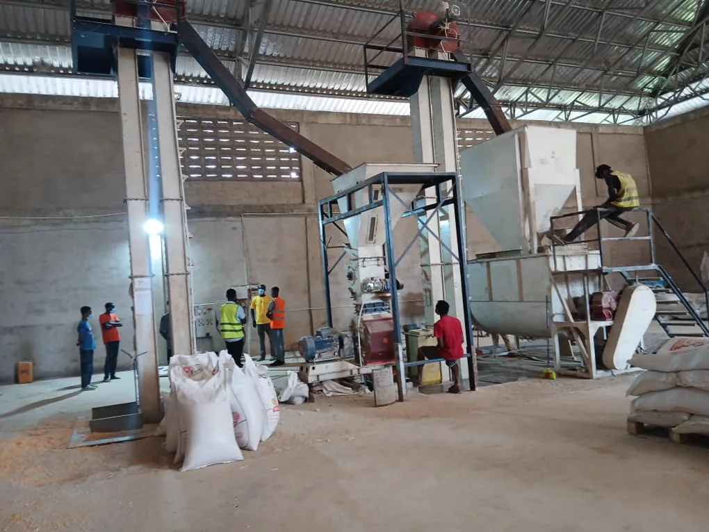 Kuapa Dwaso representatives viewing maize handling and processing equipment inside a warehouse in Takoradi