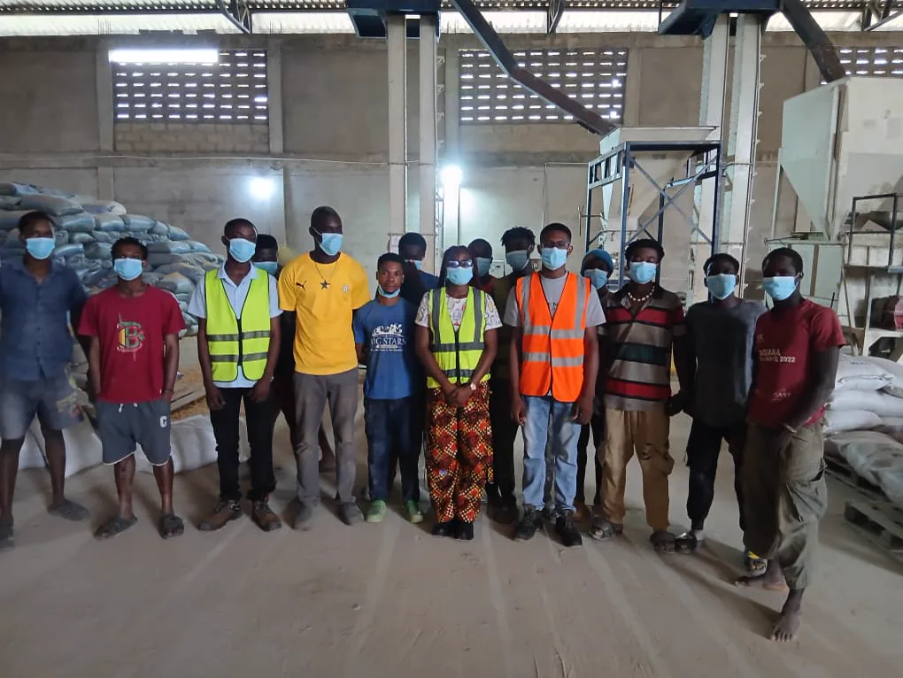 Extech staff, warehouse workers, and Kuapa Dwaso representatives standing together inside the warehouse